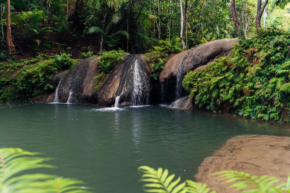 Lagaan Falls with turquoise waters surrounded by lush rainforest